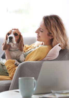 Woman petting dog in apartment