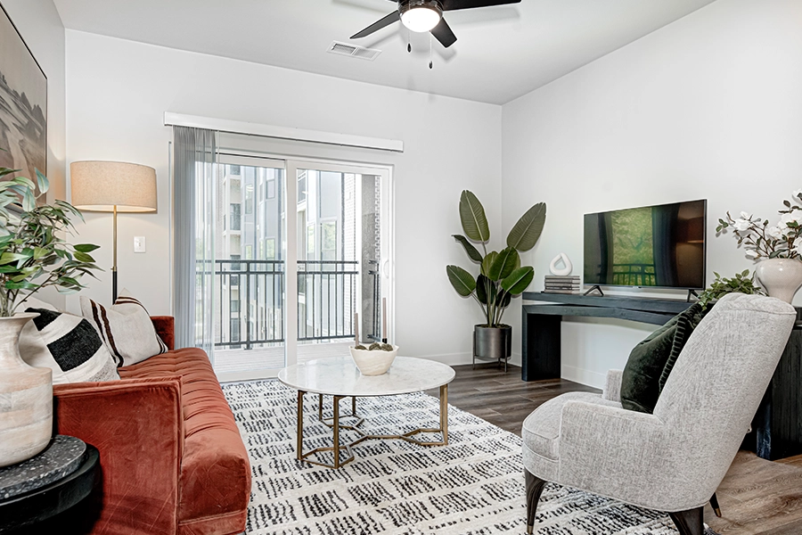 Houseplants add life to your home decor, like in this living room at East Bank Apartments. A modern apartment living room with various plants